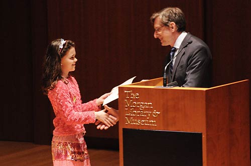 Student receiving her Award Certificate in the Gilder Lerhman Hall of the Morgan.