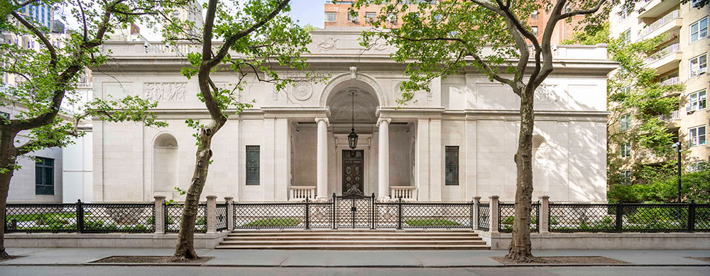 View of J. Pierpont Morgan's Library from 36th street showing gate, columns, trees.
