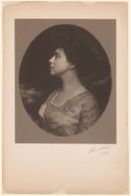 Sepia toned photograph of Belle Greene in profile looking left.