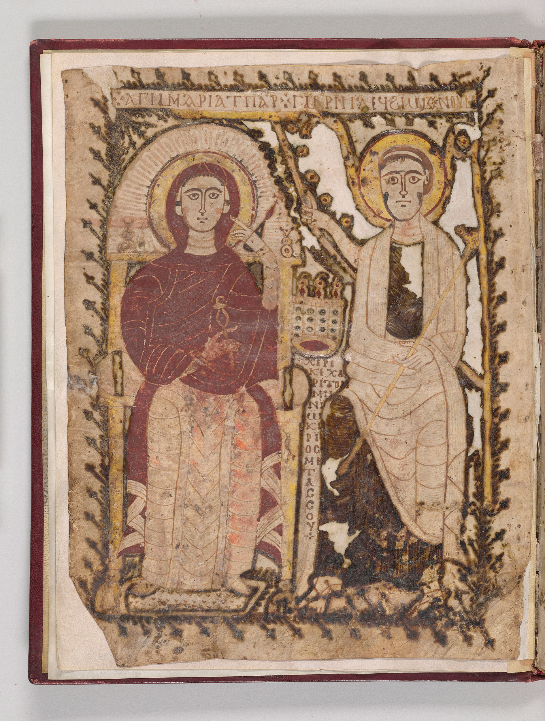 Two seated figures in robes with halos.