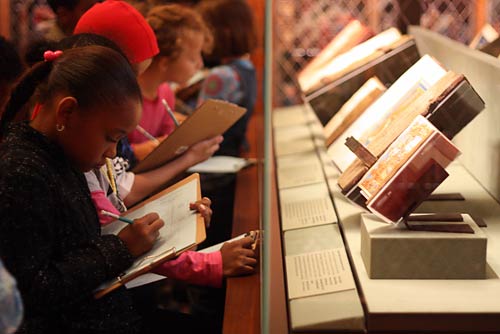 Students exploring medieval and Renaissance manuscripts in Mr. Morgan’s Library.