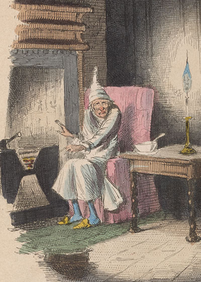 Seaetd figure of Scrooge in white night gown and cap sitting in pink armchair next to a fireplace on the left with a table and lamp on the right.