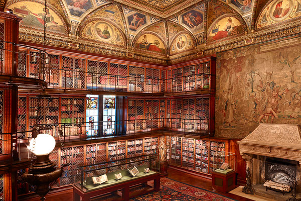 Photograph of J. Pierpont Morgan's Library interior showing bookshelves and tapestry.