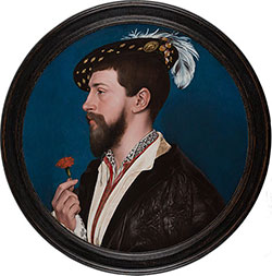 Profile portrait of bearded man holding a flower wearing feathered cap.