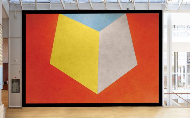 Photograph of mural with orange, yellow and blue geometric shapes.