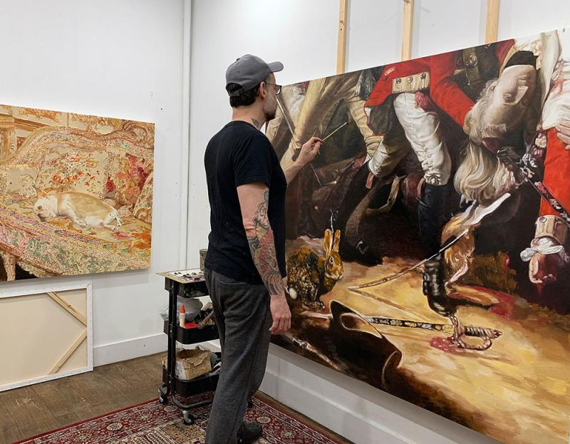 Michael Caines painting canvas in home studio.