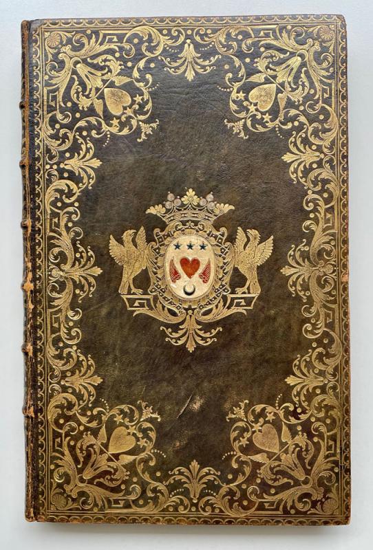 Olive leather book binding with ornate gold floral designs and coat of arms in the middle.