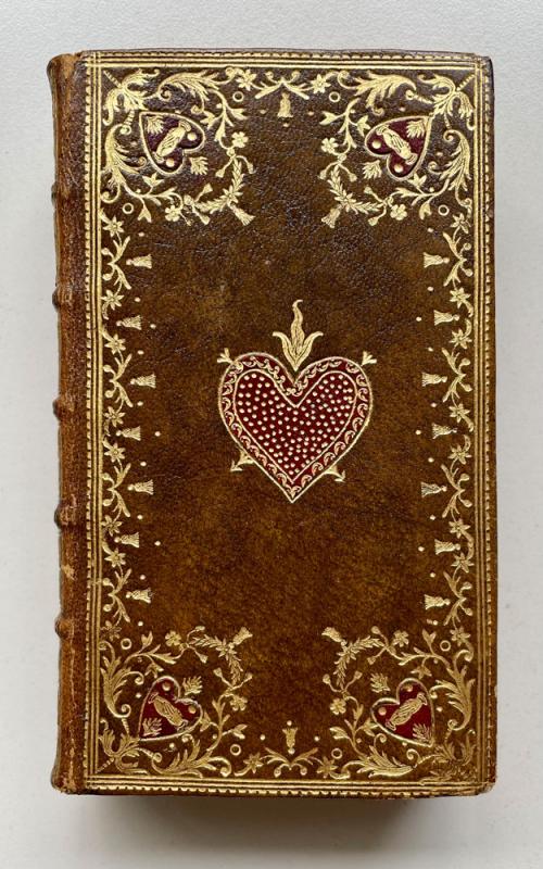 Brown book binding wirh gold floral and heart patterns.