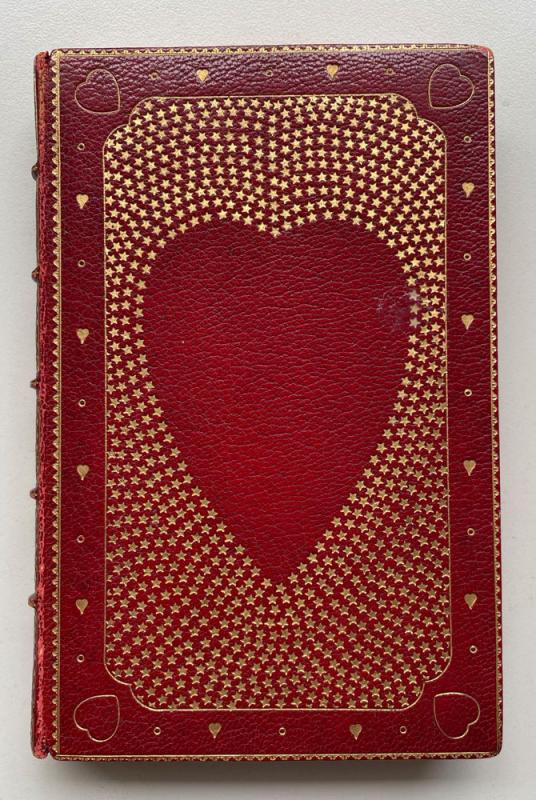 Red leather book binding with heart-shaped design made from stars.