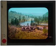 Lantern slide of landscape with four figures on horseback in foreground.