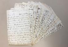 Group of handwritten letters arranged like a fan.