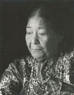 Black-and-white portrait of Nora Thompson Dean at three quarter angle looking down.