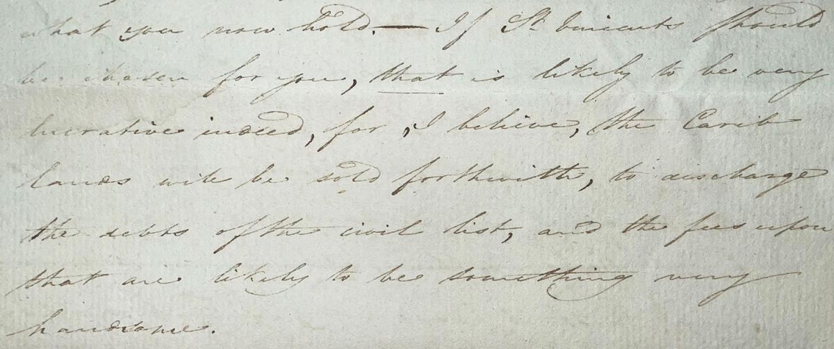 A close-up of an old document featuring handwritten cursive text in brown ink on aged, light brown paper. The script is dense and fills most of the frame.